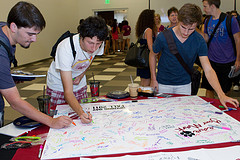 students signing poster